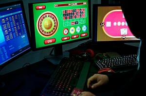 person in front of multiple monitors with casino on